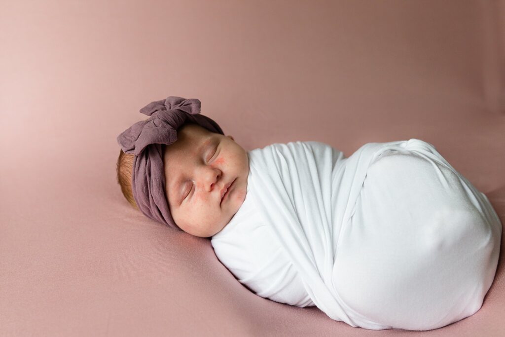 newborn photos of baby girl wrapped in white