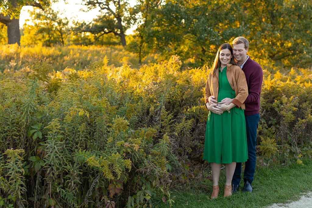 Husband and wife maternity photo holding belly, Westmont Maternity Photographer