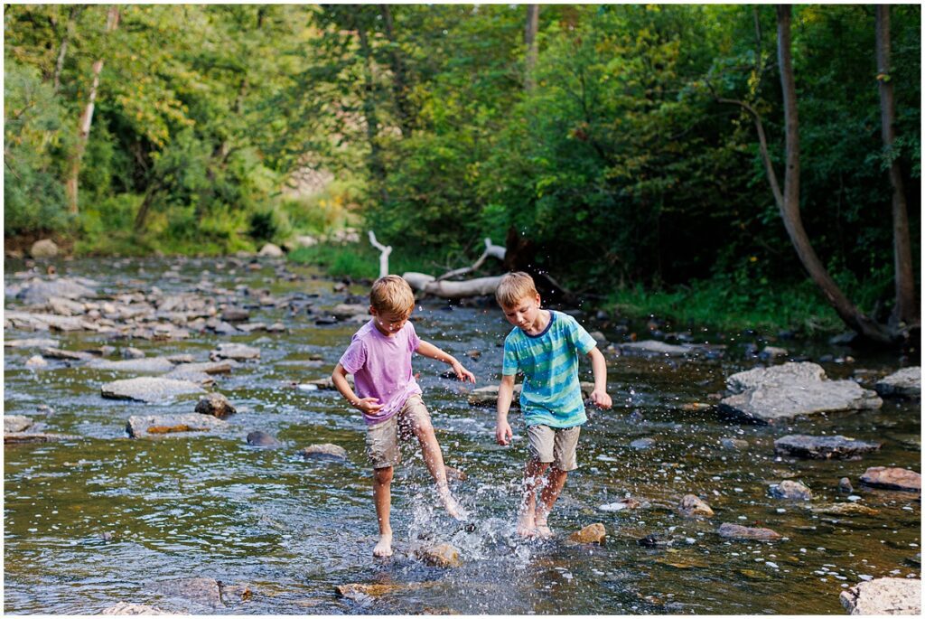 brothers splash in the creek at Waterfall Glen in Darien Illinois