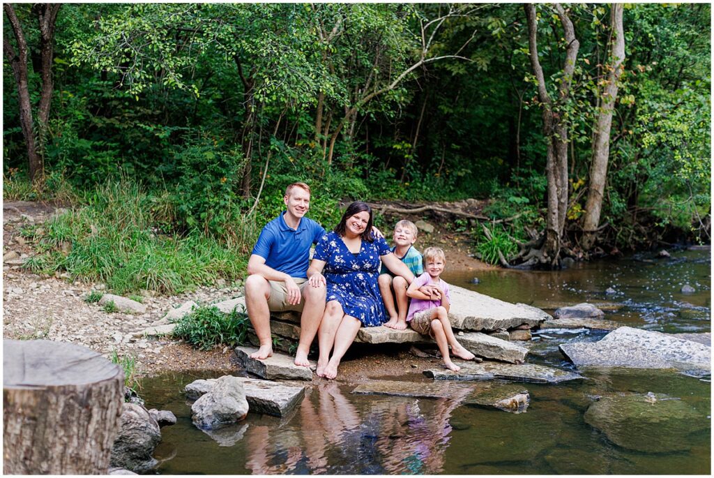 Family sitting on rocks next to creek bed, Waterfall Glen