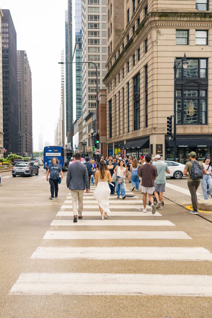 Wedding portraits in the city of Chicago while walking across a street