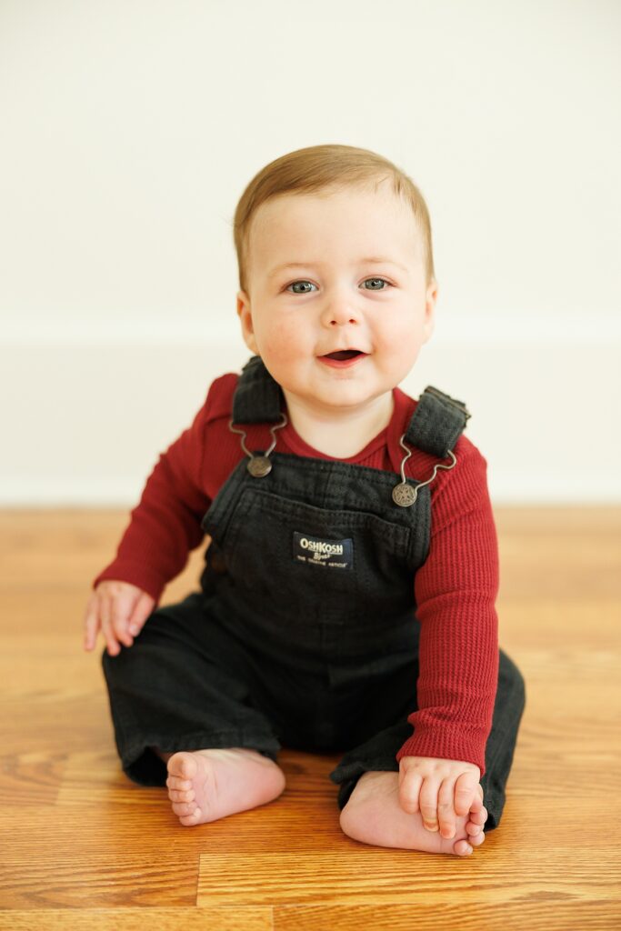 sitter milestone session with a boy in overalls